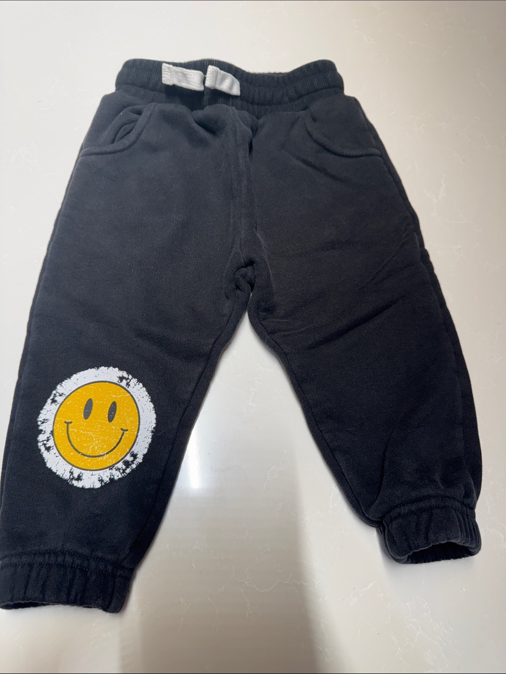 Little Bipsy Black Joggers with Yellow Smiley Patch